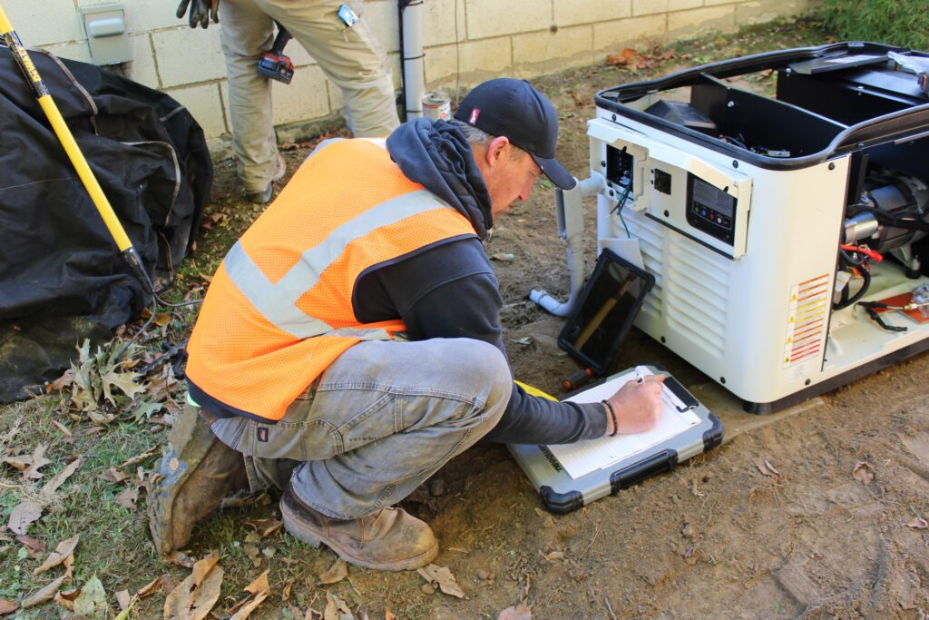 A professional electrician reviews a safety checklist after completing a generator installation, ensuring full commercial electrical safety and code compliance in the facility.
