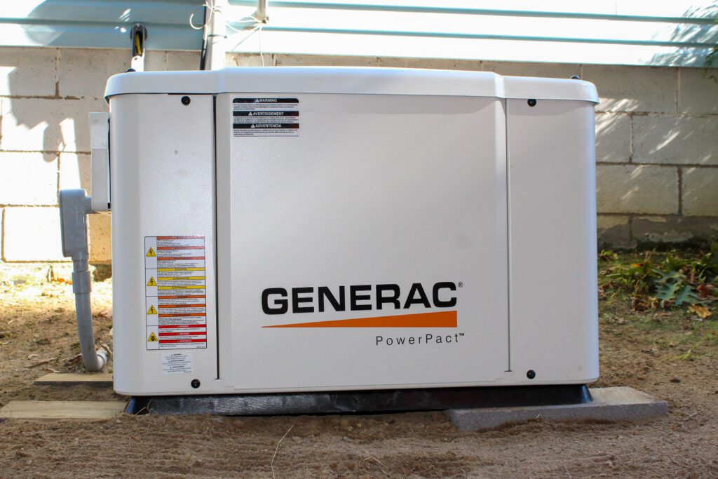 Licensed electrician performing LED lighting installation and conducting home energy audits, showcasing a newly installed residential generator for improved residential electrical energy efficiency.