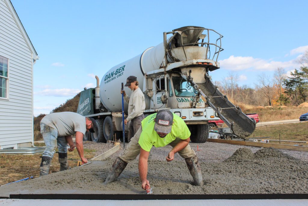 An excavation crew works on a commercial lot, demonstrating full-scale commercial construction services and careful site management.
