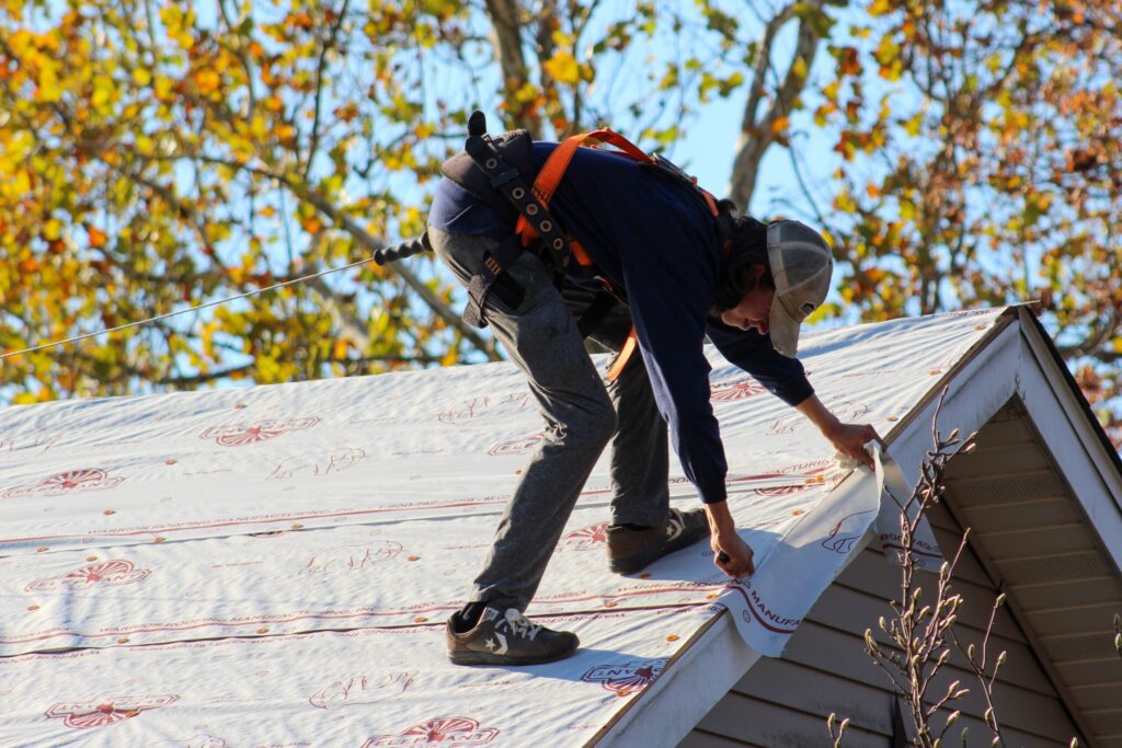 A Goodridge Construction professional applying roofing to a residential home, demonstrating residential roofing services, expert roofing systems, and reliable gutter & water management.
