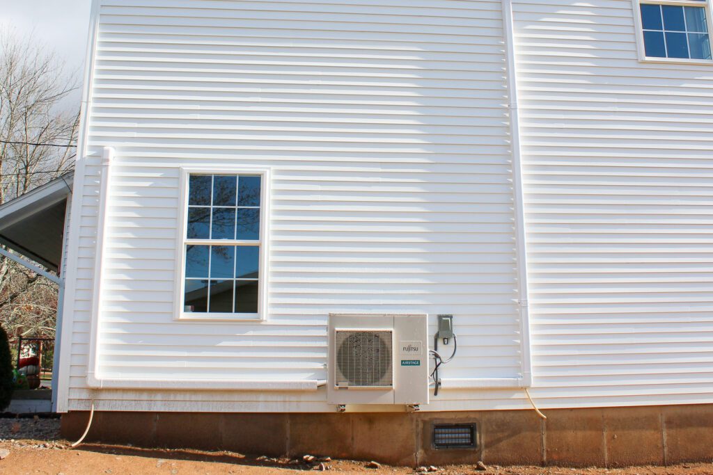 Residential HVAC installation and replacement by Goodridge Construction Group, showcasing HVAC installations and replacements and energy-efficient heating and cooling service upgrades on the side of a home.