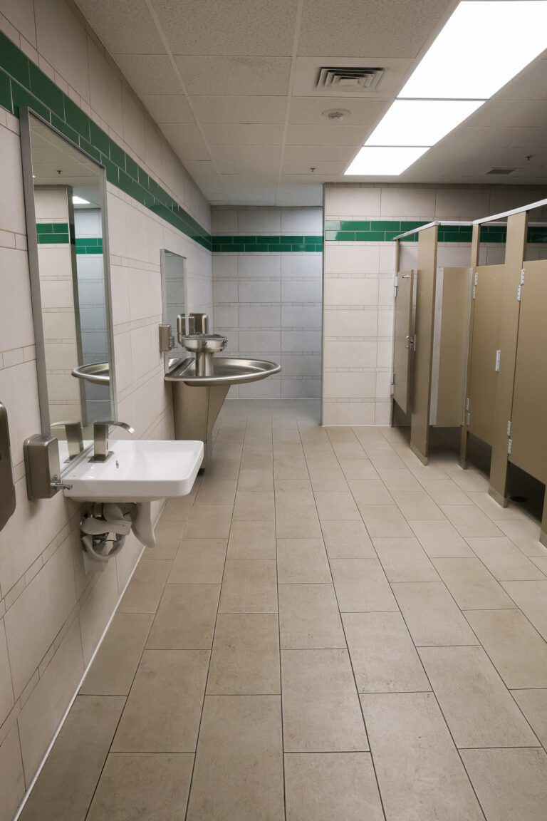 A modern commercial bathroom showcases attention to detail from expert general construction services, including finishes and fixtures.